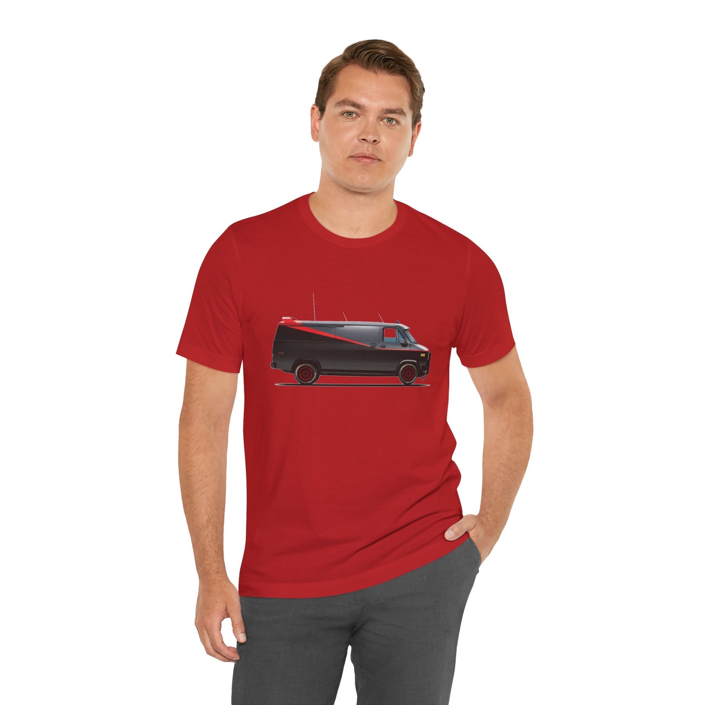A man wearing a red t-shirt with a graphic print of the adventure team van.