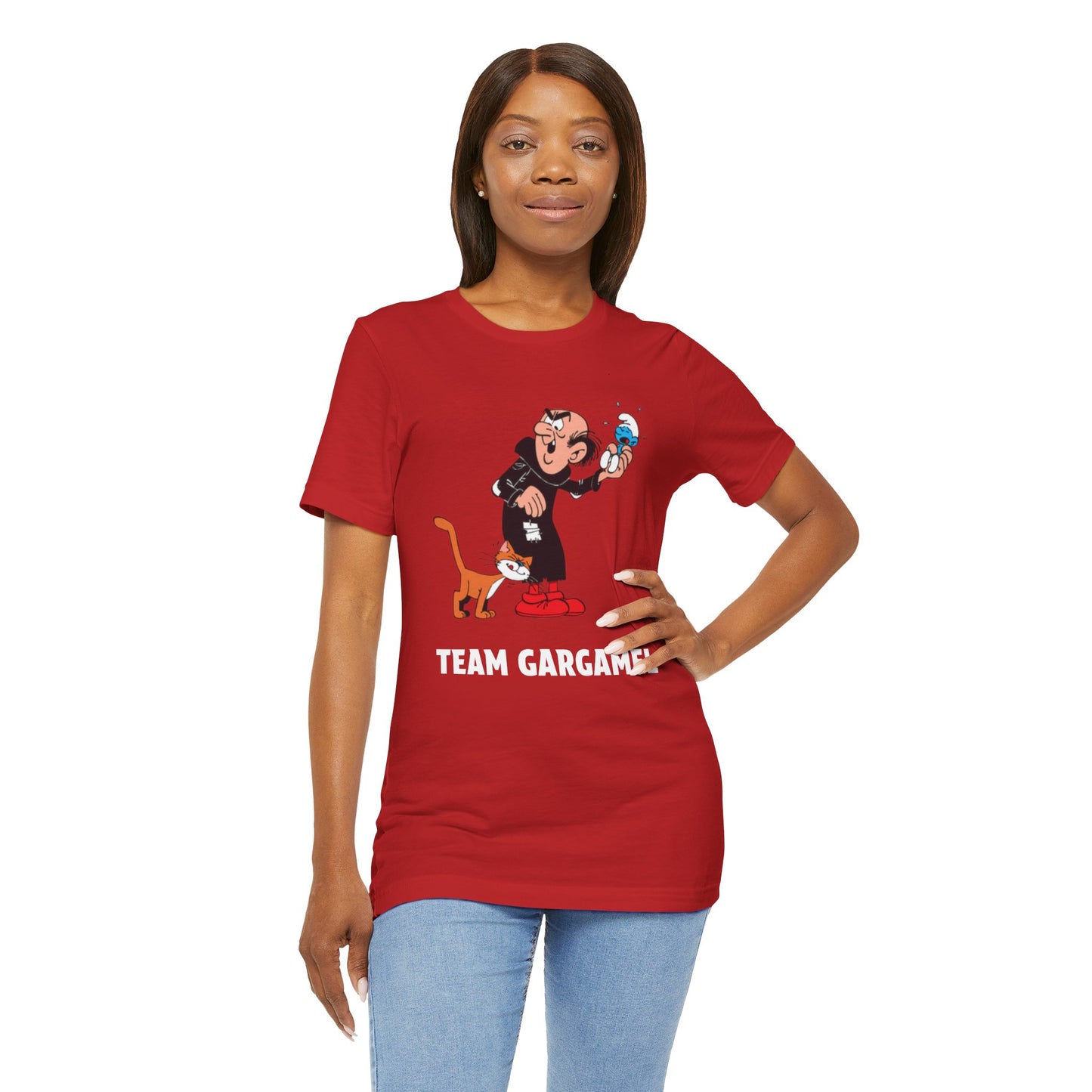 A woman modeling a red short-sleeve graphic t-shirt with a cartoon character and the text 'TEAM GARGAMEL' on the front.