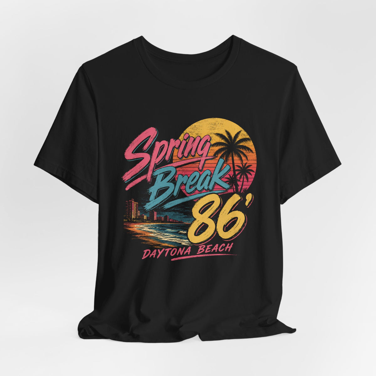 A crewneck t-shirt featuring a colorful retro graphic on the front that reads 'Spring Break 86 Daytona Beach' with a sunset and palm tree design.