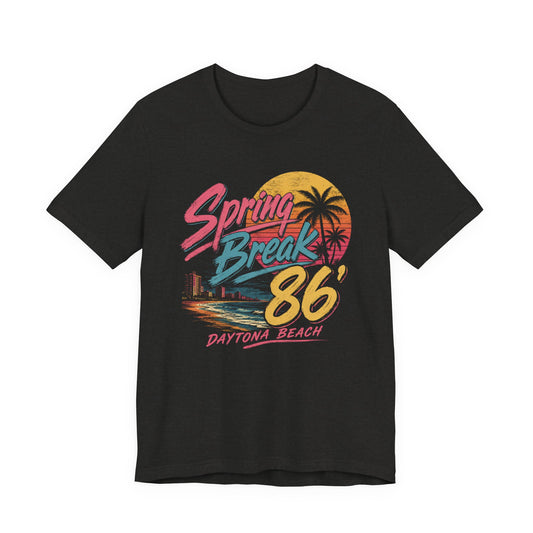 A black short-sleeve t-shirt featuring a colorful retro graphic on the front that reads 'Spring Break 86 Daytona Beach' with a sunset and palm tree design.