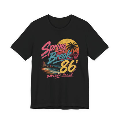 A crewneck t-shirt featuring a colorful retro graphic on the front that reads 'Spring Break 86 Daytona Beach' with a sunset and palm tree design.