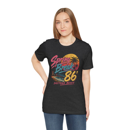A crewneck t-shirt featuring a colorful retro graphic on the front that reads 'Spring Break 86 Daytona Beach' with a sunset and palm tree design.