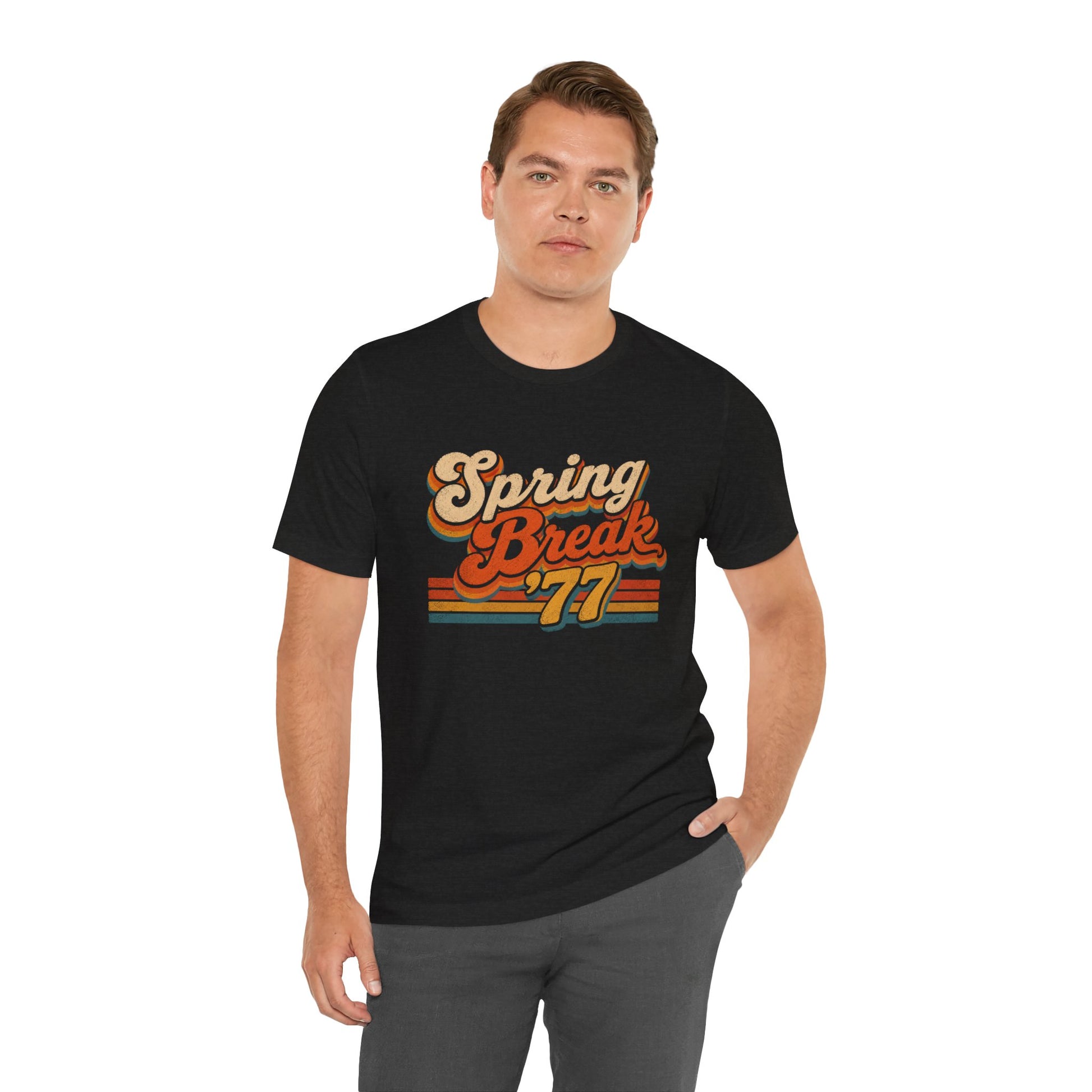 A man wearing a black short-sleeve t-shirt with a retro-style 'Spring Break '77' graphic in orange, yellow, and red.