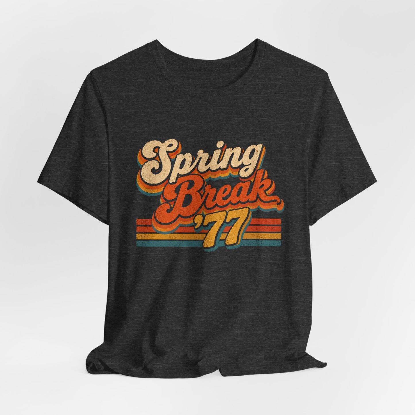 A  heather gray t-shirt featuring a retro-style 'Spring Break '77' graphic print in orange, yellow, and beige tones.