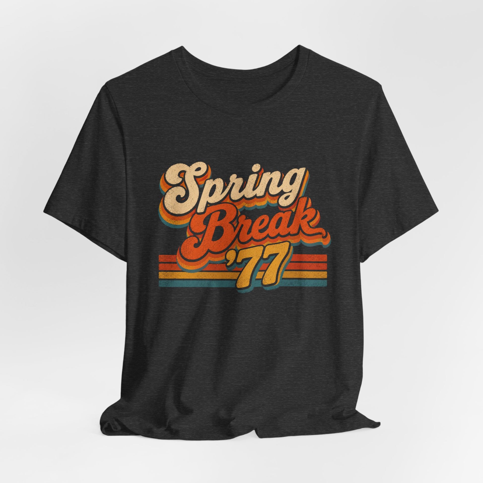 A  heather gray t-shirt featuring a retro-style 'Spring Break '77' graphic print in orange, yellow, and beige tones.