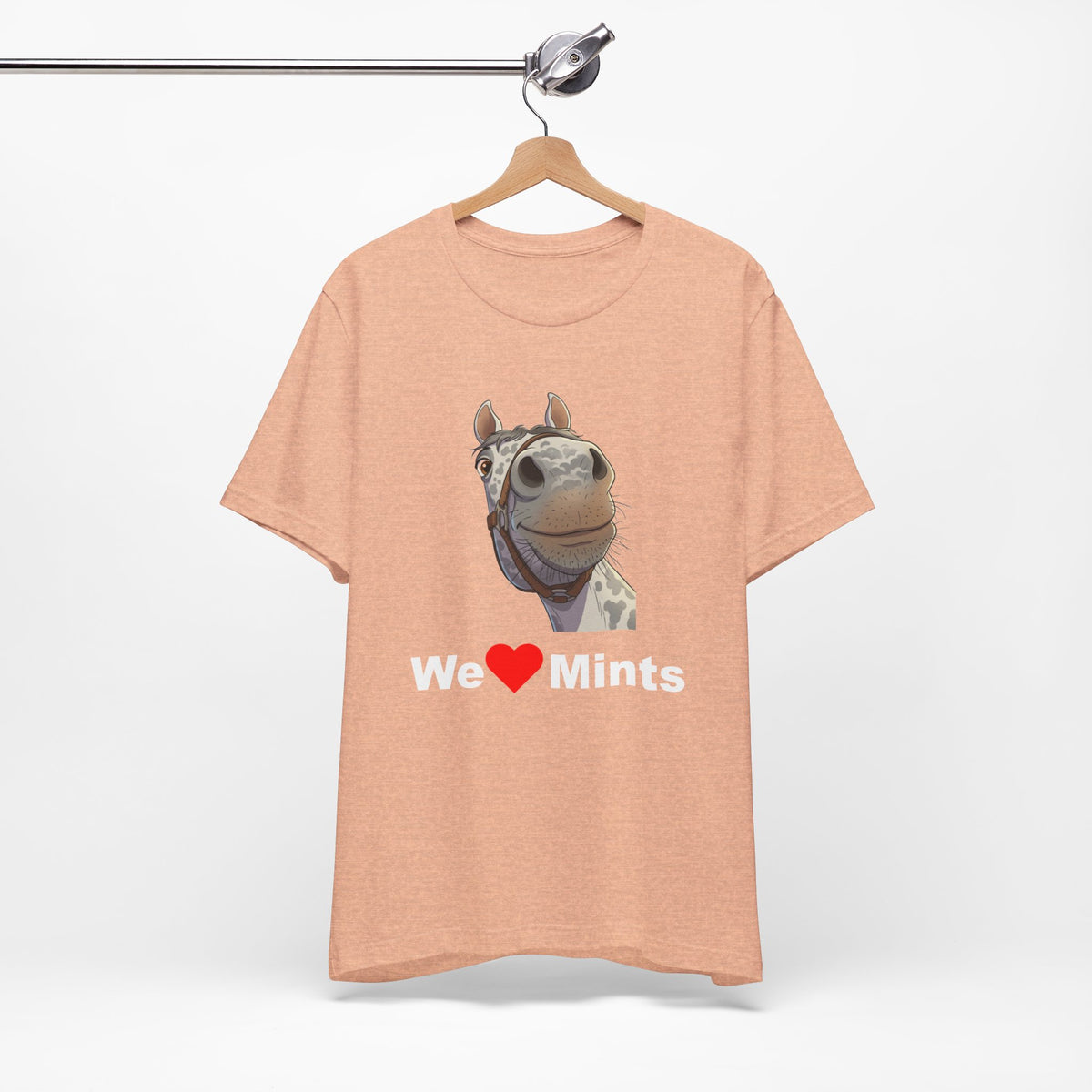 A peach short-sleeve t-shirt featuring a graphic of a horse's face above the text 'We Love Mints'.
