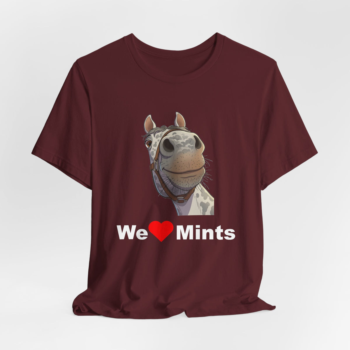 A maroon short-sleeve t-shirt featuring a graphic of a horse's face above the text 'We Love Mints'.
