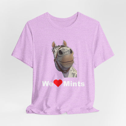 A pink short-sleeve t-shirt featuring a graphic of a horse's face above the text 'We Love Mints'.
