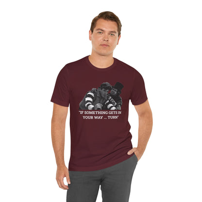 A maroon short-sleeve t-shirt with a graphic from Better Off Dead.