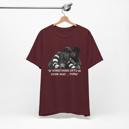 A maroon short-sleeve t-shirt with a graphic from Better Off Dead.