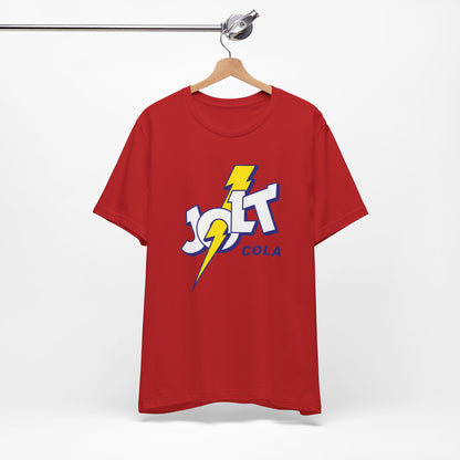 A red short-sleeve crewneck t-shirt featuring a retro-style 'Jolt Cola' logo graphic on the chest with a yellow lightning bolt.