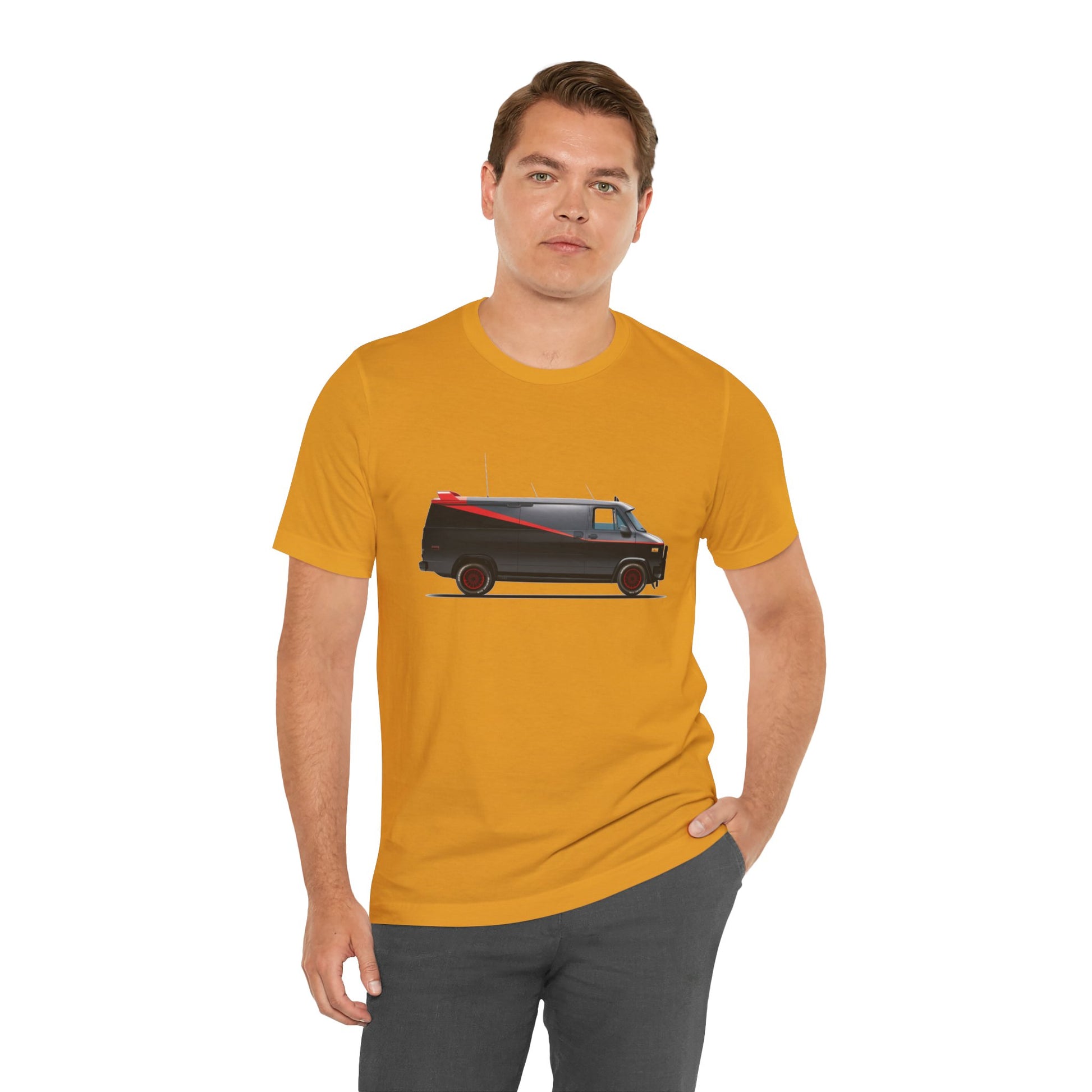 A man wearing a mustard yellow t-shirt with a graphic print of the adventure team van.