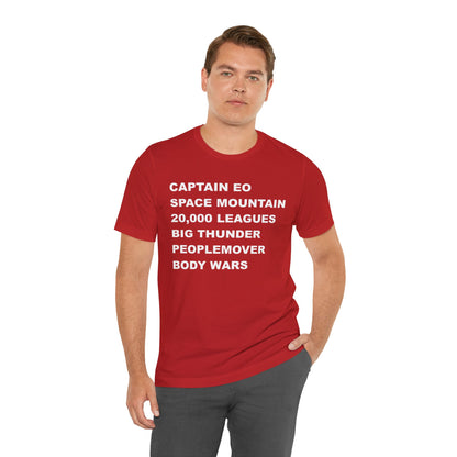 A red short-sleeve crewneck t-shirt with bold white text on the front listing old retro disney rides.