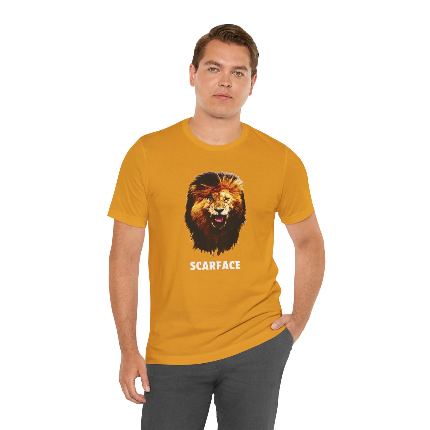 A mustard short-sleeve t-shirt featuring a graphic of a roaring lion's head with the word 'SCARFACE' printed in white below it.