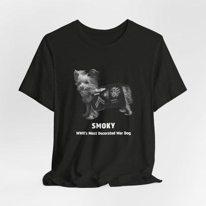 A black short-sleeve crewneck t-shirt featuring a grayscale graphic of a small dog wearing a decorated military-style jacket, with the text 'SMOKY WWII'S Most Decorated War Dog' printed below.