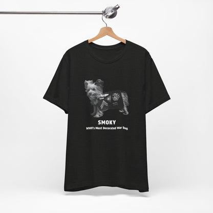 A black short-sleeve t- shirt features a grayscale graphic of a dog wearing a military combat coat with the text 'SMOKY' and 'WII'S MOST Decorated War Dog' printed below.