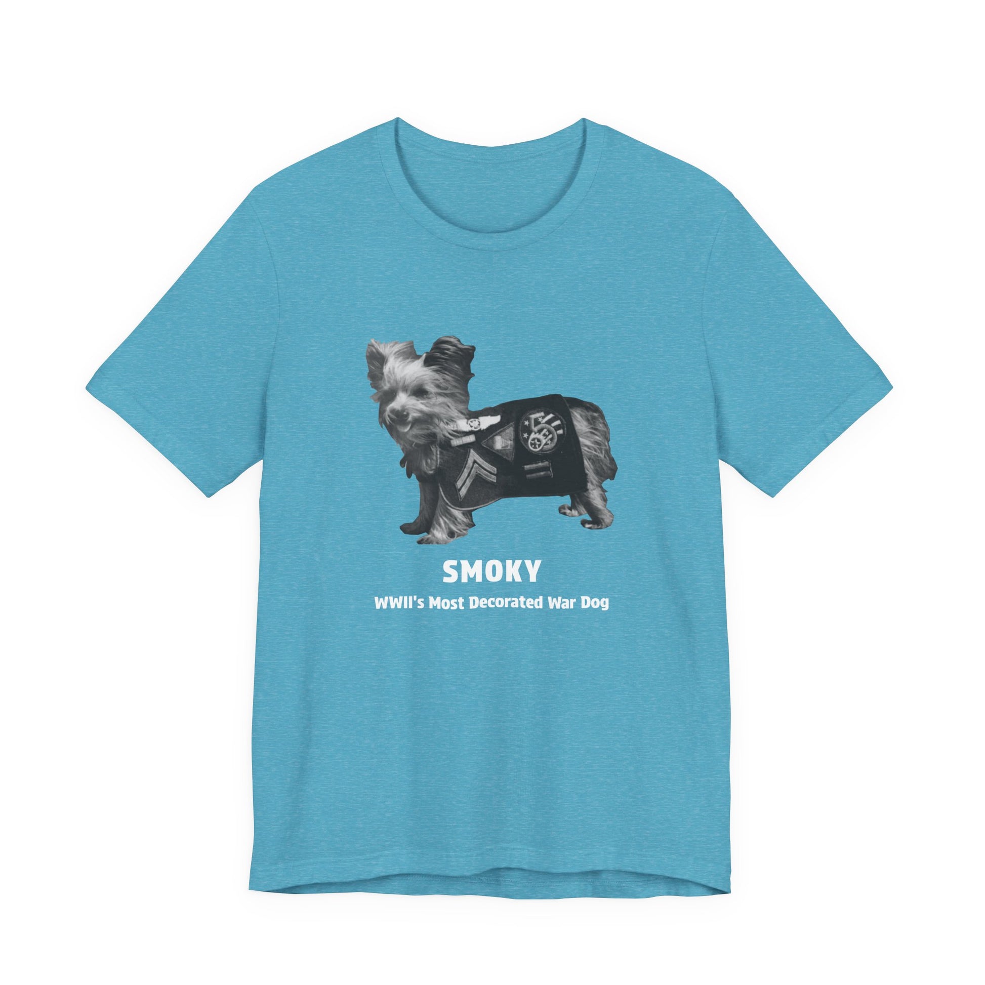 A heather aqua short-sleeve crewneck t-shirt featuring a black and white graphic of a small dog wearing a military combat coat, with the text 'SMOKY WWII'S Most Decorated War Dog' printed below.