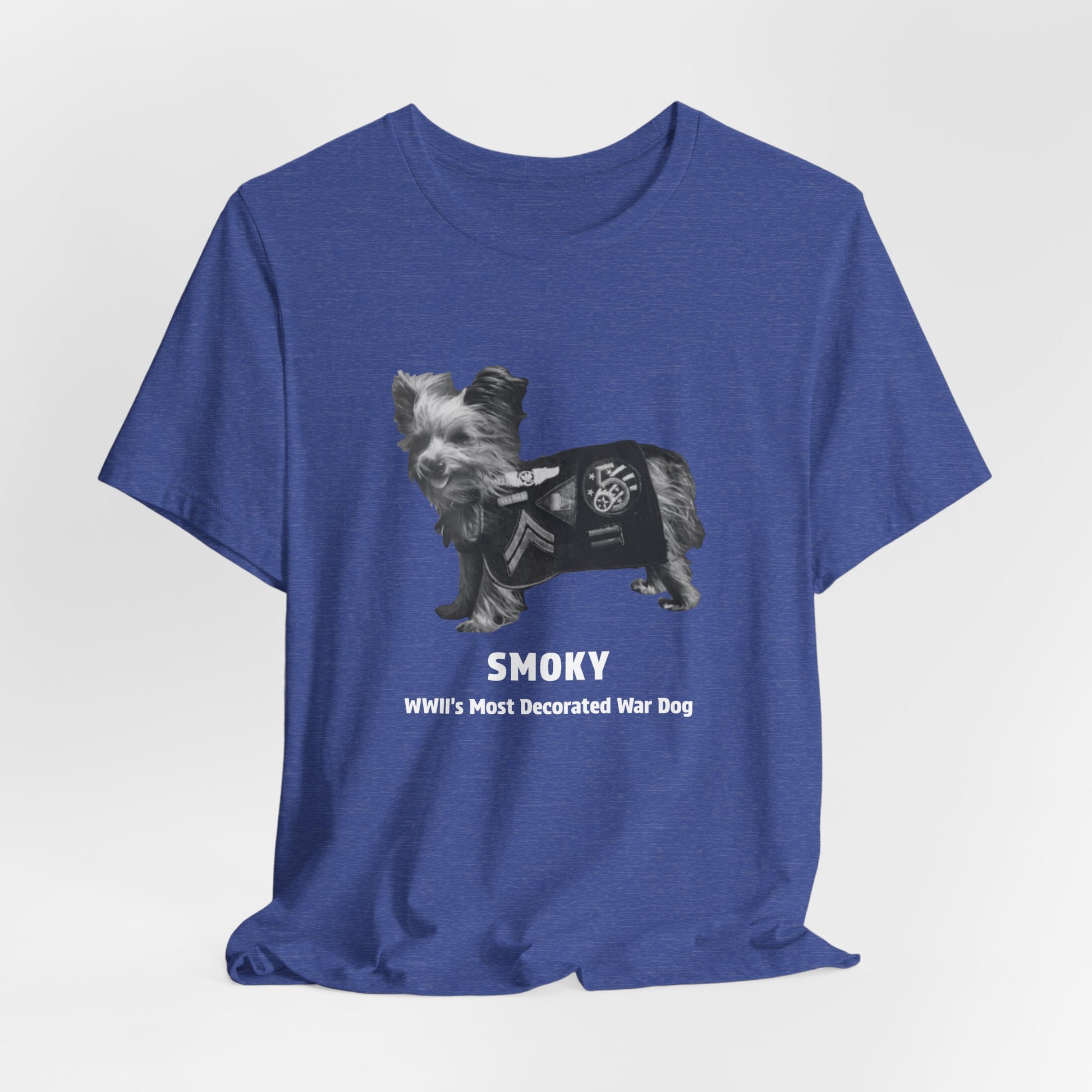A heather blue short-sleeve t-shirt with a graphic of a small dog wearing a black bandana and the text 'SMOKY WWII's Most Decorated War Dog' printed on the front.