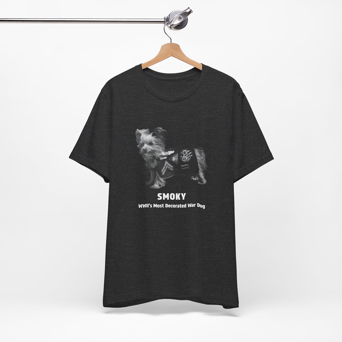 A  heather gray short-sleeve t-shirt featuring a black and white graphic of a dog wearing a WWII service jacket with the text 'SMOKY WWII'S MOST DECORATED WAR DOG'.