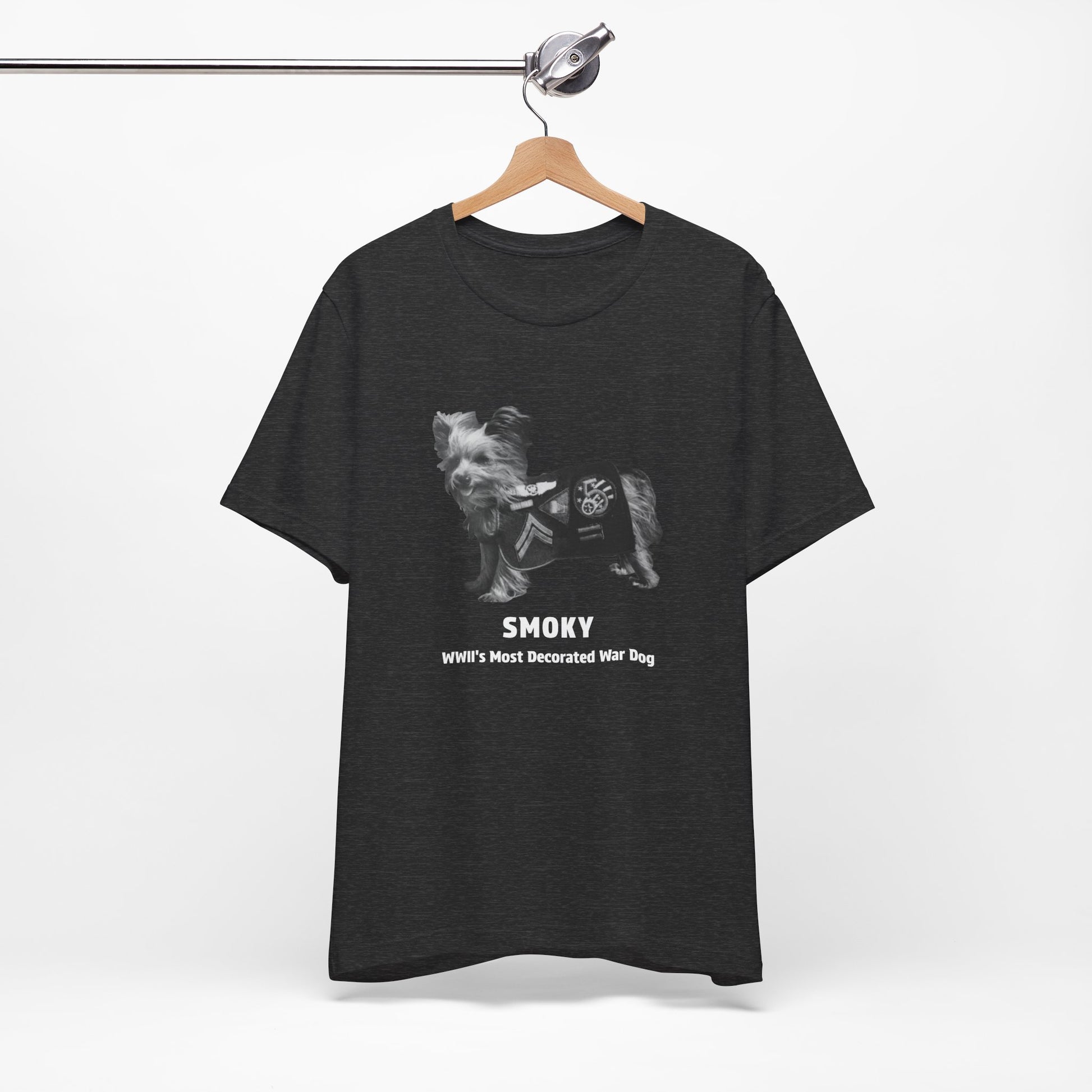 A  heather gray short-sleeve t-shirt featuring a black and white graphic of a dog wearing a WWII service jacket with the text 'SMOKY WWII'S MOST DECORATED WAR DOG'.