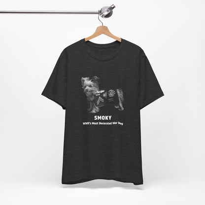 A  heather gray short-sleeve t-shirt featuring a black and white graphic of a dog wearing a WWII service jacket with the text 'SMOKY WWII'S MOST DECORATED WAR DOG'.