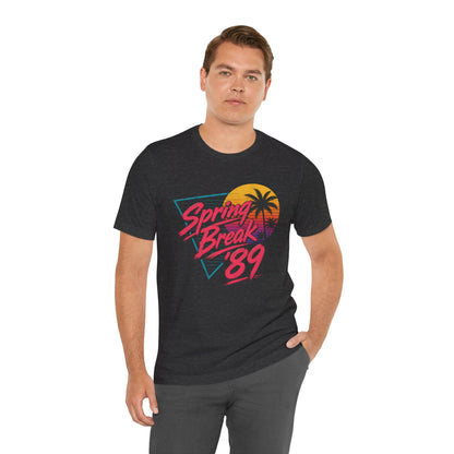 A crewneck t-shirt featuring a colorful retro graphic on the front that reads 'Spring Break 89' with a sunset and palm tree design.