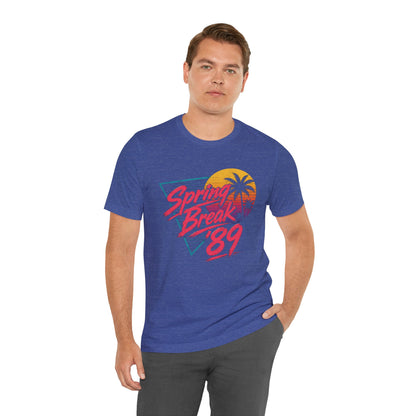 A crewneck t-shirt featuring a colorful retro graphic on the front that reads 'Spring Break 89' with a sunset and palm tree design.