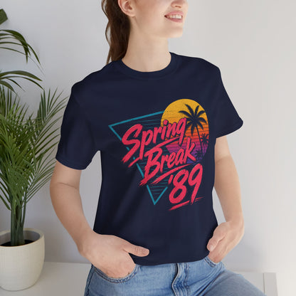 A crewneck t-shirt featuring a colorful retro graphic on the front that reads 'Spring Break 89' with a sunset and palm tree design.