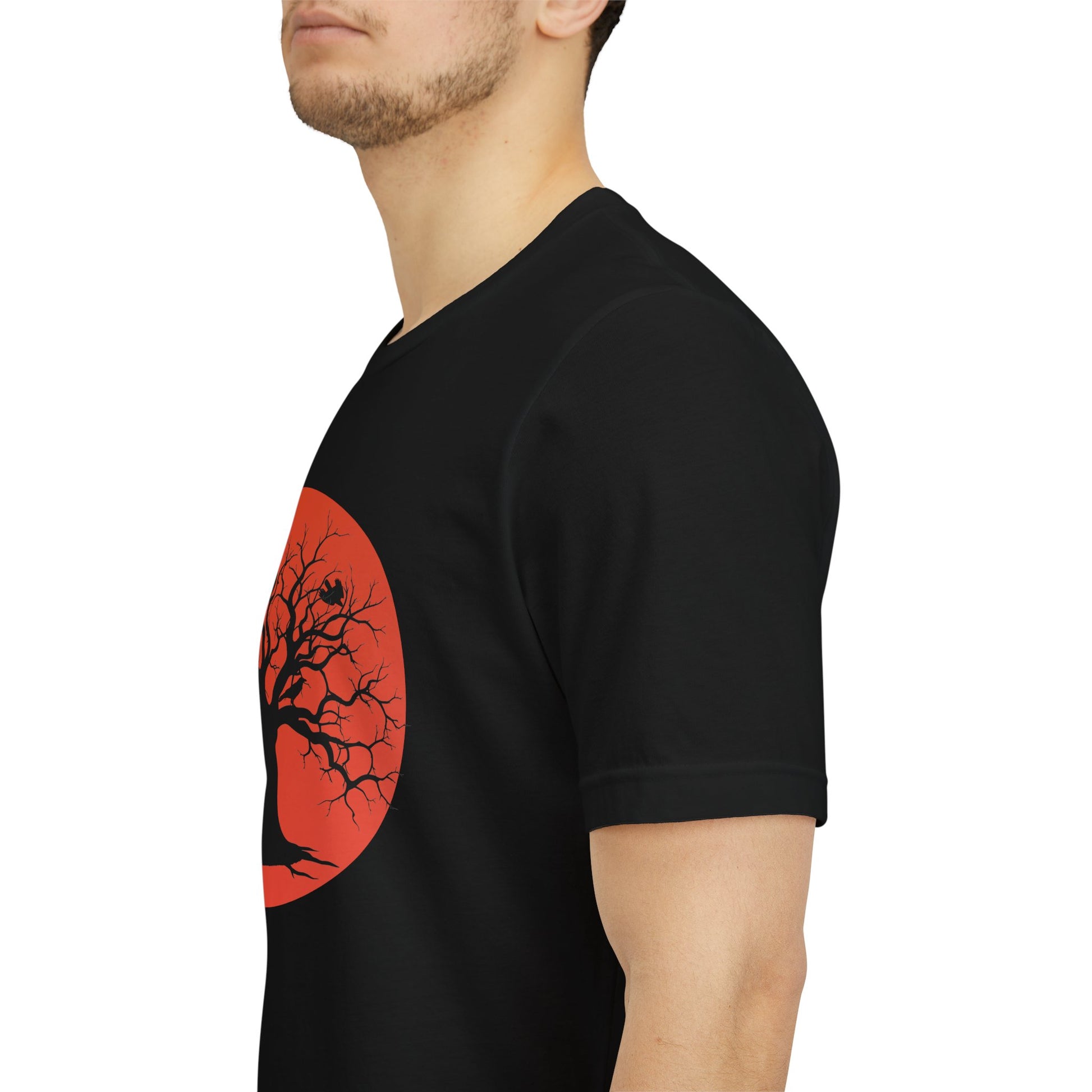 A black short-sleeve crewneck t-shirt featuring a graphic print of a black tree silhouette against a large blood moon with perched ravens.