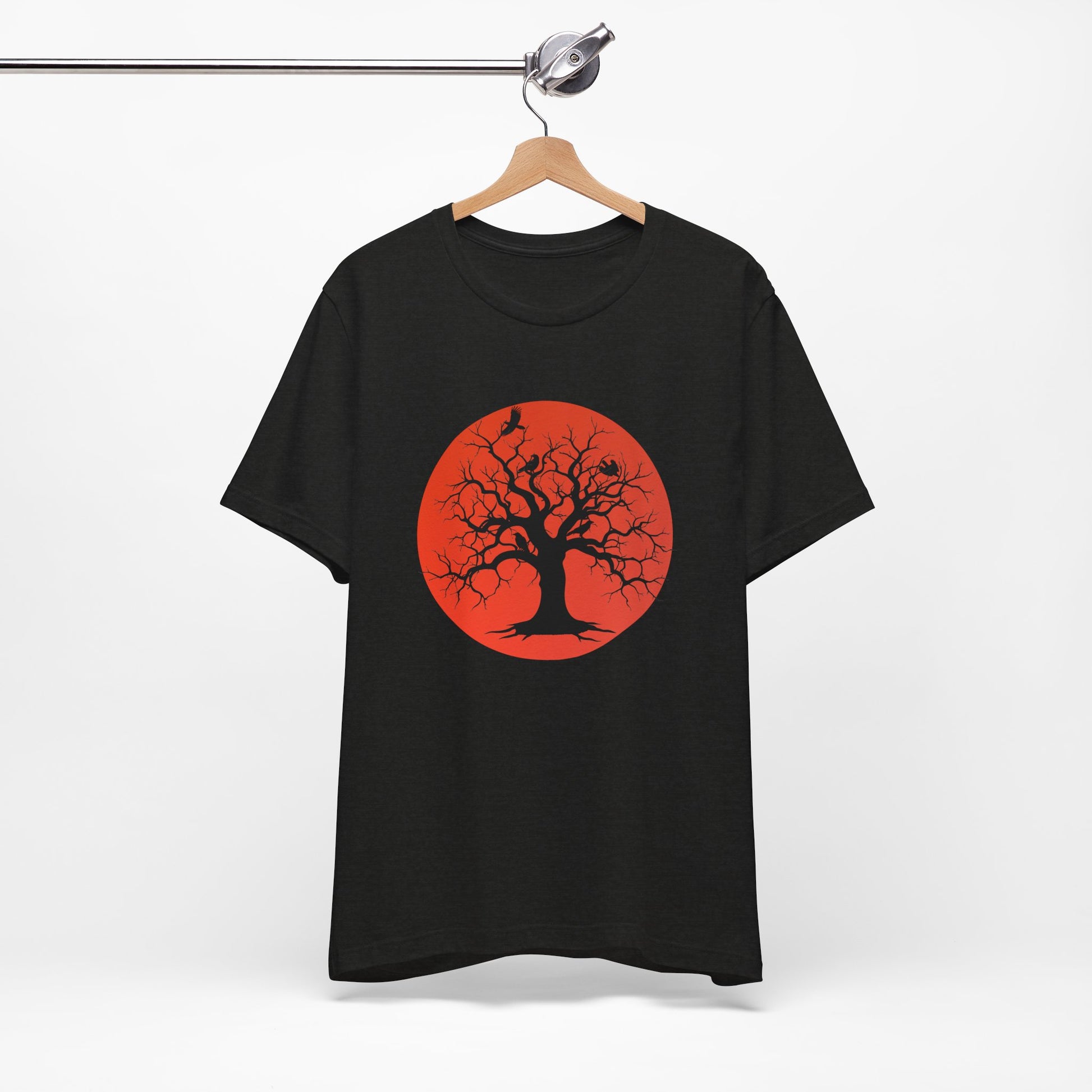 A black short-sleeve crewneck t-shirt featuring a graphic print of a black tree silhouette against a large blood moon with perched ravens.