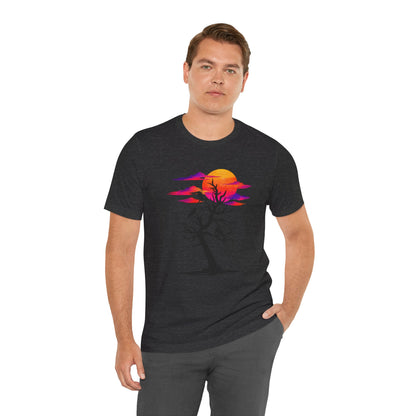 Tree of Ravens graphic tee featuring a black leafless tree with three ravens against a vibrant retro purple and orange sunset.