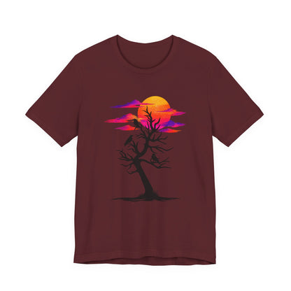 Tree of Ravens graphic tee featuring a black leafless tree with three ravens against a vibrant retro purple and orange sunset.
