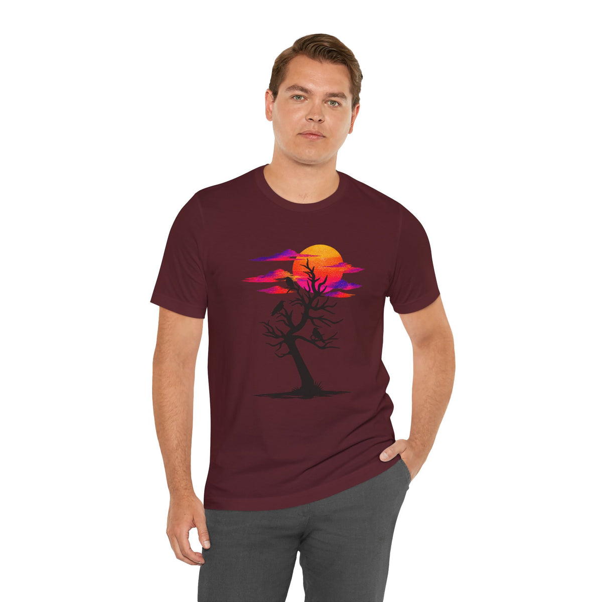 Tree of Ravens graphic tee featuring a black leafless tree with three ravens against a vibrant retro purple and orange sunset.