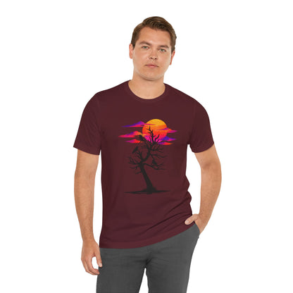 Tree of Ravens graphic tee featuring a black leafless tree with three ravens against a vibrant retro purple and orange sunset.