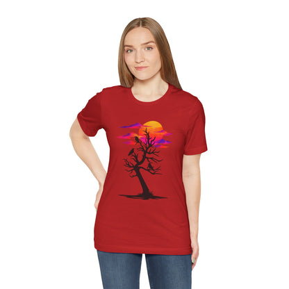 Tree of Ravens graphic tee featuring a black leafless tree with three ravens against a vibrant retro purple and orange sunset.